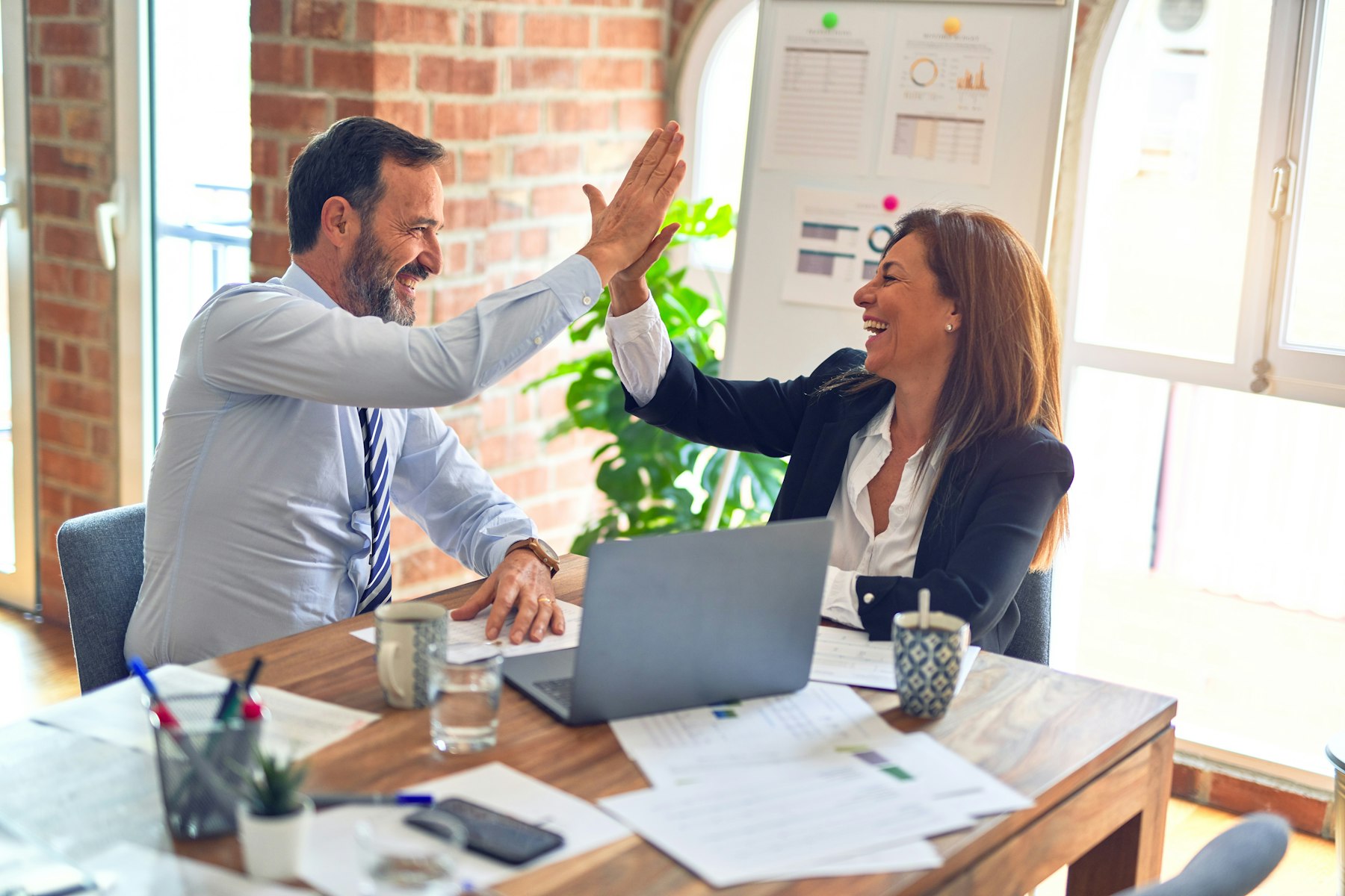 Two professionals reviewing documents together in a meeting